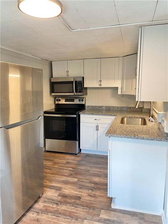 811 Carlisle Street, Unit 2 New Castle, PA 16101 - Photo 9 of 23 a kitchen with kitchen island a sink stainless steel appliances and cabinets