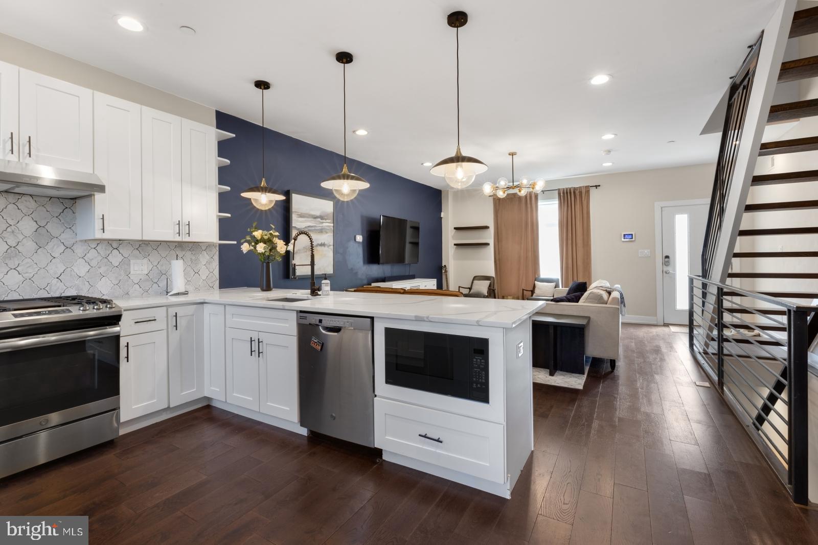 2707 West Stiles Street Philadelphia, PA 19121 - Photo 7 of 43 a kitchen with stainless steel appliances granite countertop a stove a sink and a refrigerator