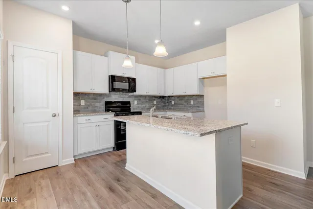 a kitchen with a stove a sink and a refrigerator