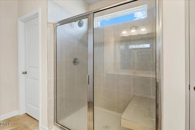 a bathroom with a glass shower door