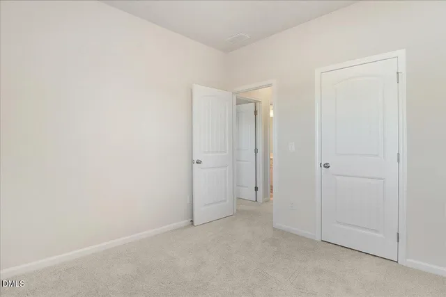an empty room with closet area