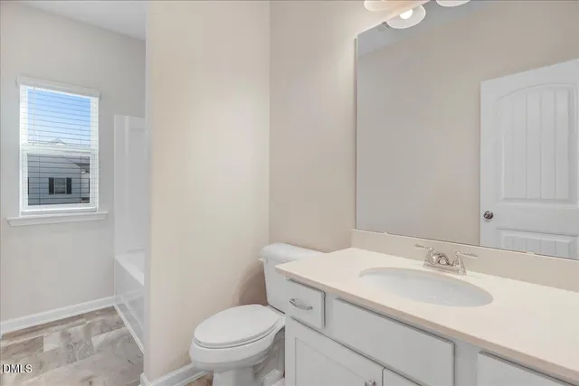 a bathroom with a sink toilet and a mirror