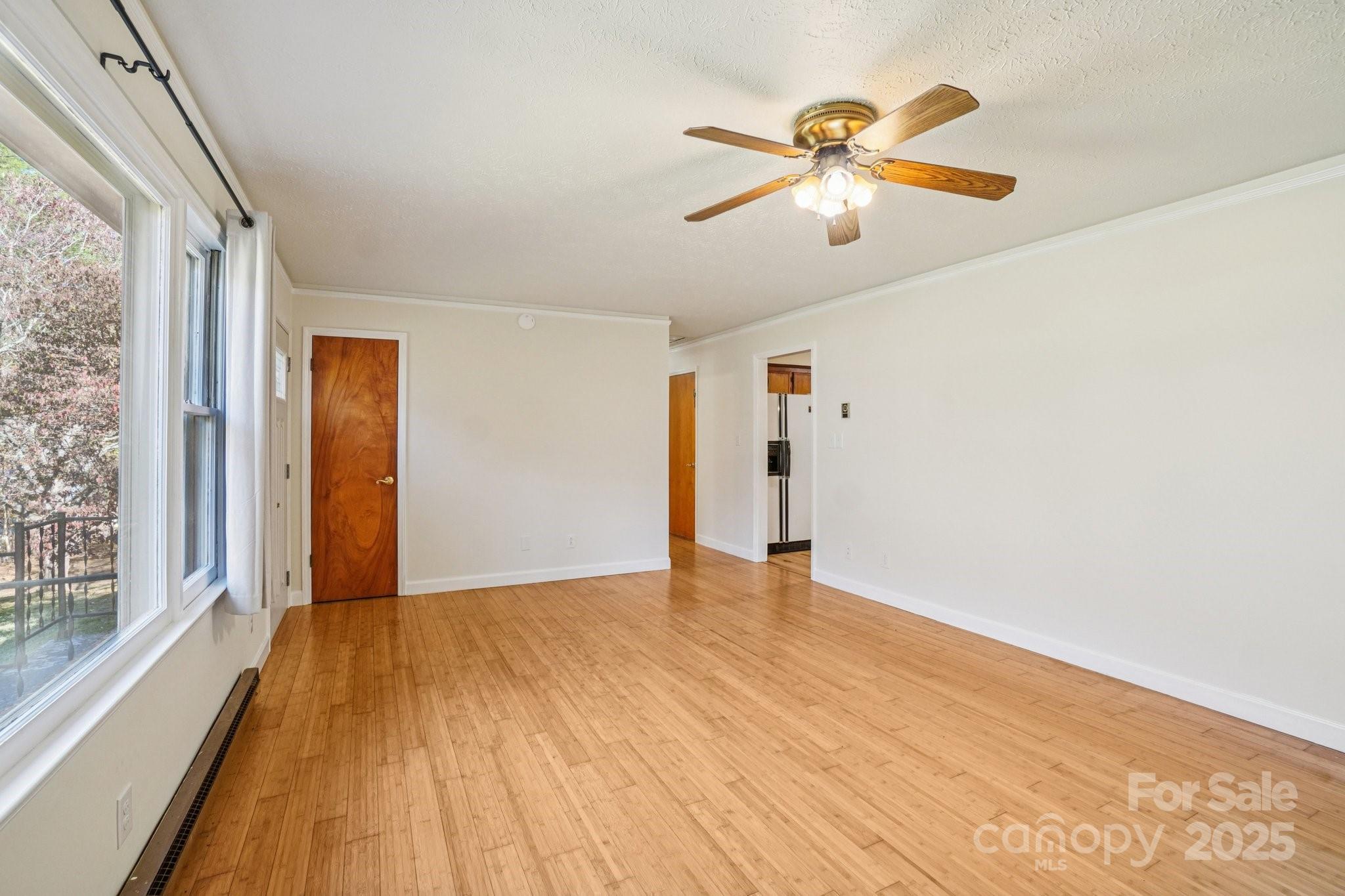 480 Paint Fork Road Barnardsville, NC 28709 - Photo 11 of 43 a view of an empty room with wooden floor and a window