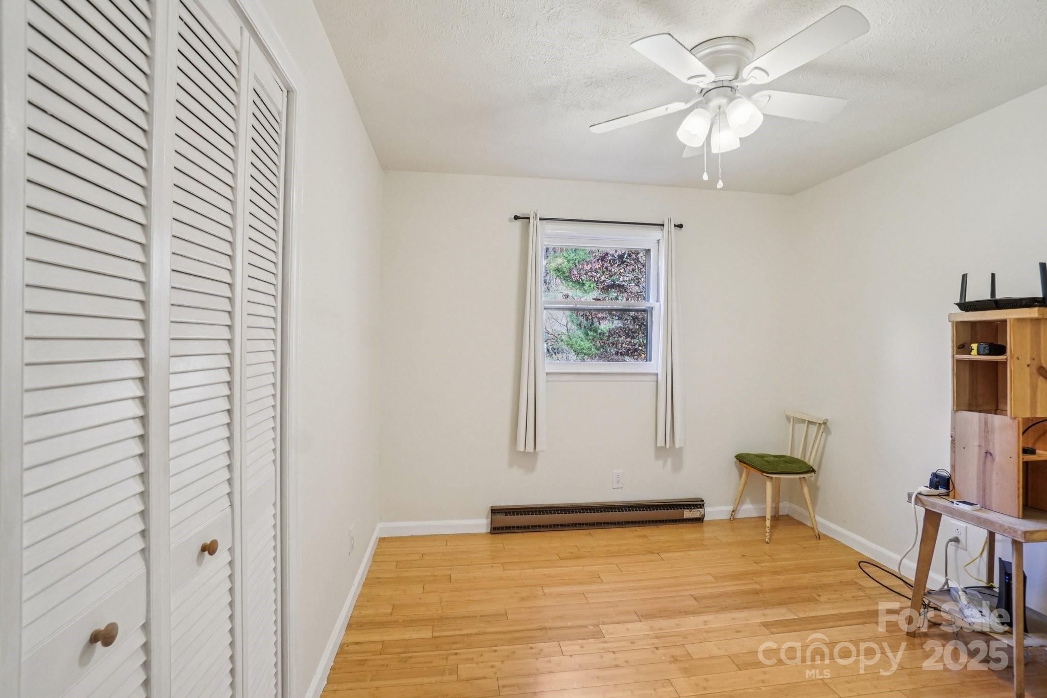 480 Paint Fork Road Barnardsville, NC 28709 - Photo 17 of 43 a view of an empty room with a window and wooden floor