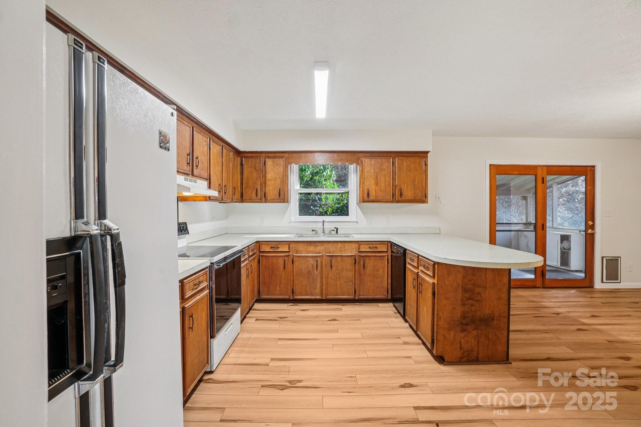 480 Paint Fork Road Barnardsville, NC 28709 - Photo 18 of 43 a kitchen with stainless steel appliances granite countertop a stove a sink and a refrigerator