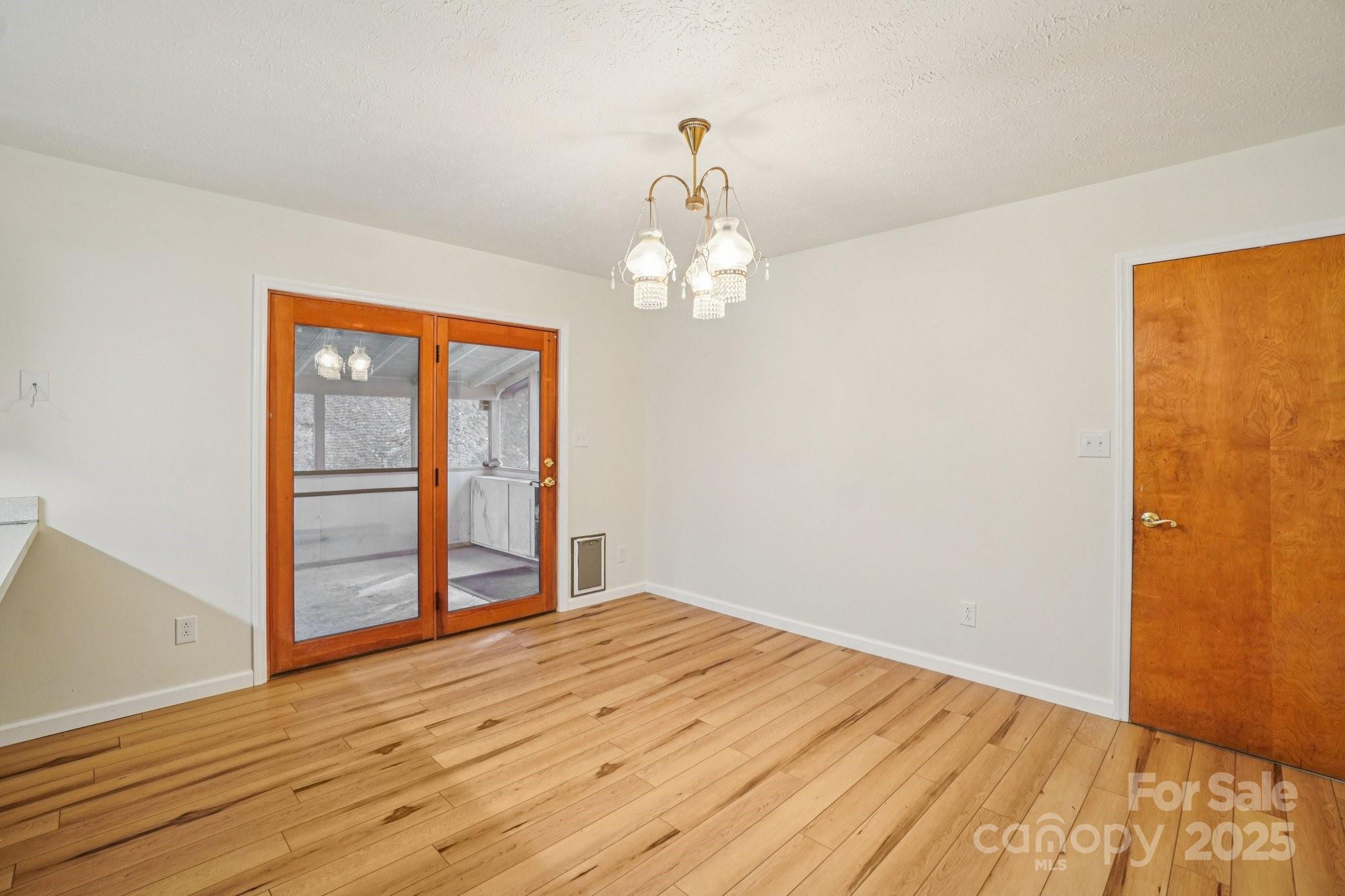 480 Paint Fork Road Barnardsville, NC 28709 - Photo 22 of 43 a view of empty room with wooden floor and fan