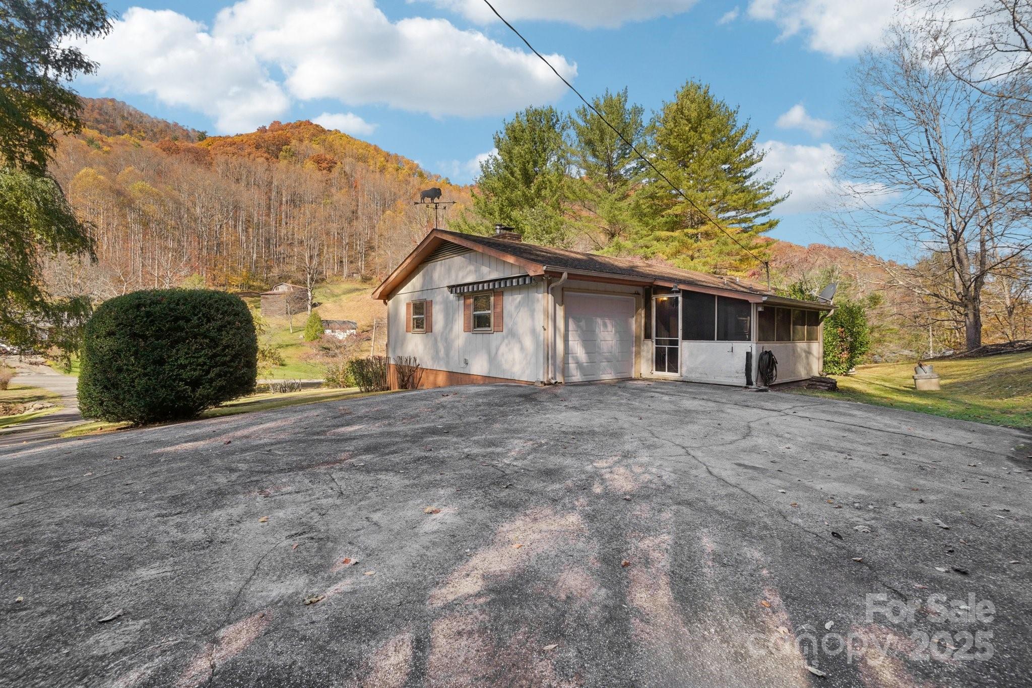 480 Paint Fork Road Barnardsville, NC 28709 - Photo 27 of 43 a view of a house with a backyard and trees