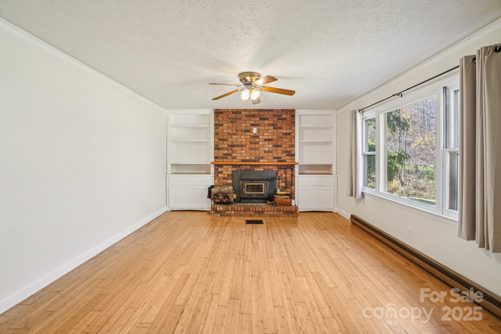 480 Paint Fork Road Barnardsville, NC 28709 - Photo 9 of 43 a view of a livingroom with wooden floor and a window