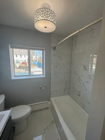 a bathroom with a toilet a sink and bathtub