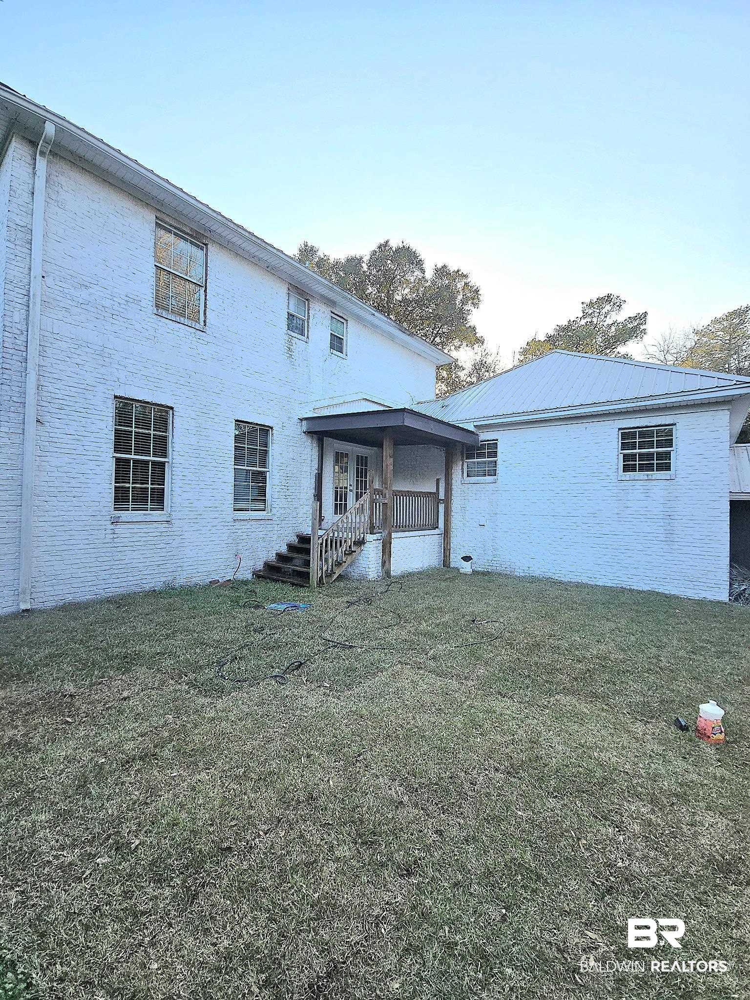 11835 Island Drive Foley, AL 36535 - Photo 44 of 53 Rear view of house featuring a yard, a porch, and a metal roof
