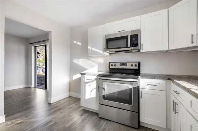 a kitchen with a stove and a microwave
