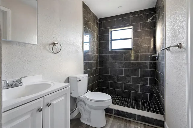 a bathroom with a toilet a sink and a shower