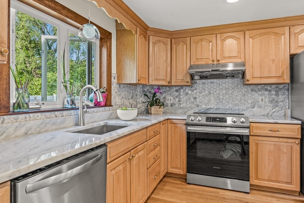 11 Main Street Winchester, MA 01890 - Photo 14 of 41 a kitchen with granite countertop a sink stainless steel appliances and cabinets