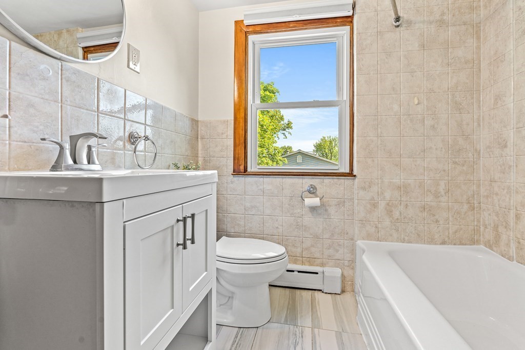 11 Main Street Winchester, MA 01890 - Photo 15 of 41 a bathroom with a sink a toilet and shower