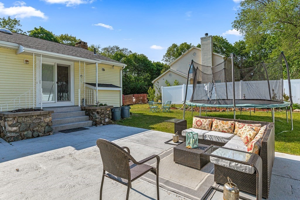 11 Main Street Winchester, MA 01890 - Photo 31 of 41 a view of a backyard with furniture and a fire pit
