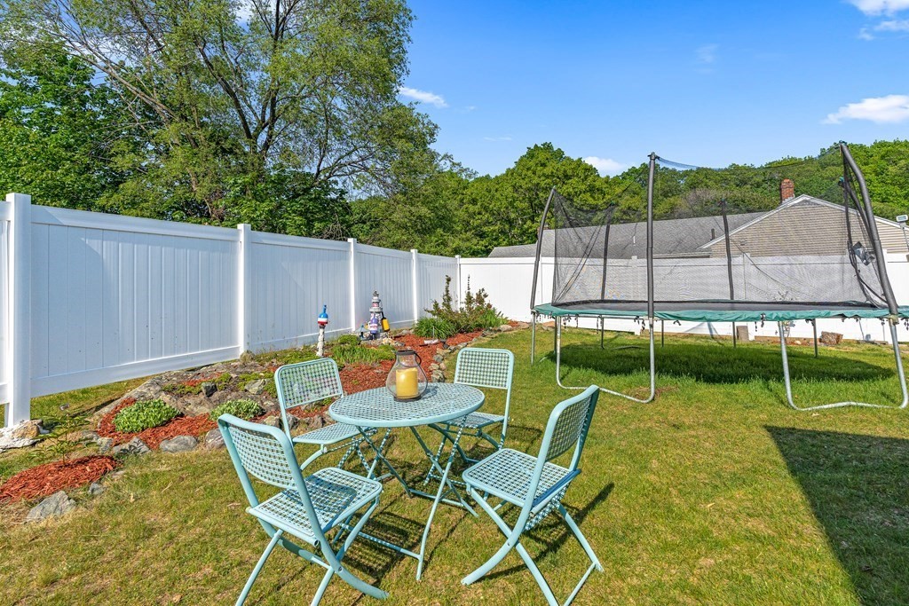 11 Main Street Winchester, MA 01890 - Photo 33 of 41 a view of a chair and table in the backyard