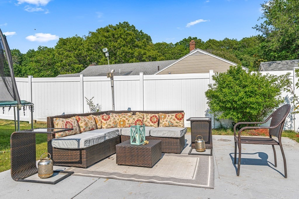 11 Main Street Winchester, MA 01890 - Photo 37 of 41 a view of a patio with couches table and chairs with wooden fence