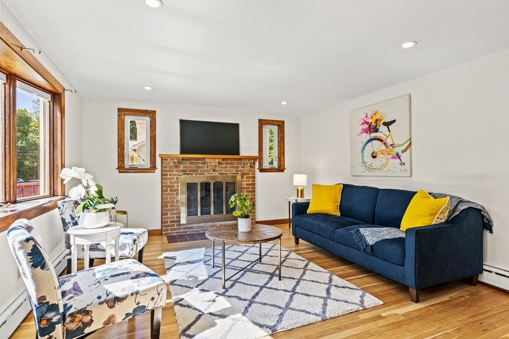 11 Main Street Winchester, MA 01890 - Photo 4 of 41 a living room with furniture a flat screen tv and a fireplace
