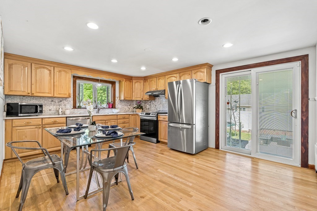 11 Main Street Winchester, MA 01890 - Photo 8 of 41 a kitchen with stainless steel appliances granite countertop a refrigerator and a stove top oven