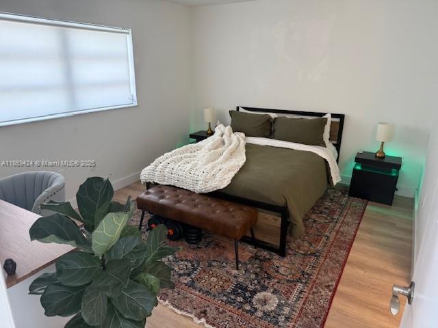 1150 Collins Avenue, Unit 503 Miami Beach, FL 33139 - Photo 1 of 12 a bedroom with a bed table and a window