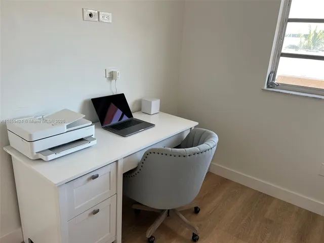 a room with a table chairs and wooden floor