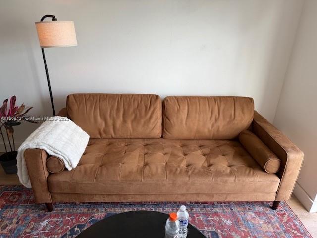 1150 Collins Avenue, Unit 503 Miami Beach, FL 33139 - Photo 3 of 12 a living room with a couch