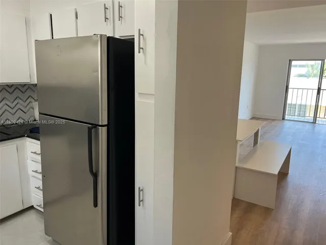 a refrigerator freezer sitting inside of a kitchen