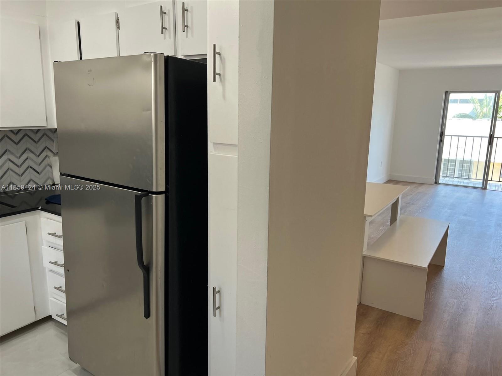 1150 Collins Avenue, Unit 503 Miami Beach, FL 33139 - Photo 6 of 12 a refrigerator freezer sitting inside of a kitchen