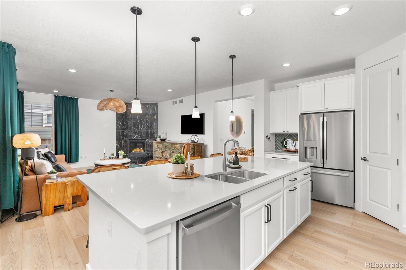 6267 North Florence Way Denver, CO 80238 - Photo 11 of 41 a kitchen with stainless steel appliances kitchen island granite countertop a sink a microwave and a refrigerator