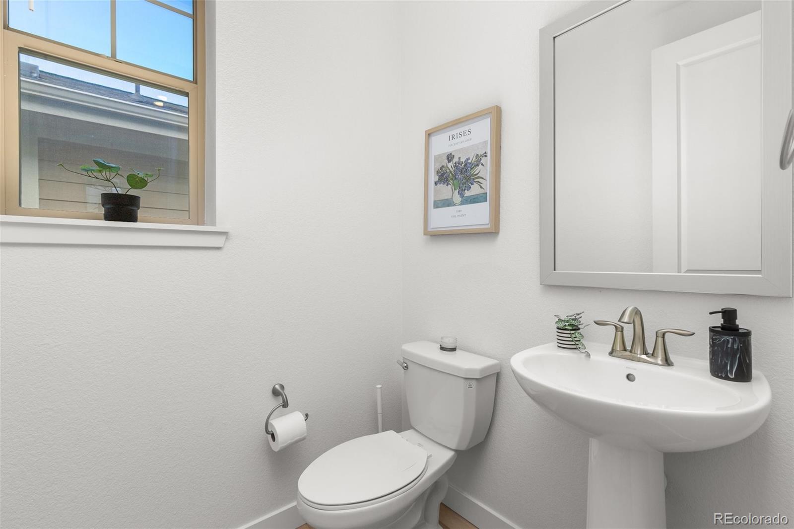 6267 North Florence Way Denver, CO 80238 - Photo 14 of 41 a bathroom with a sink mirror and toilet