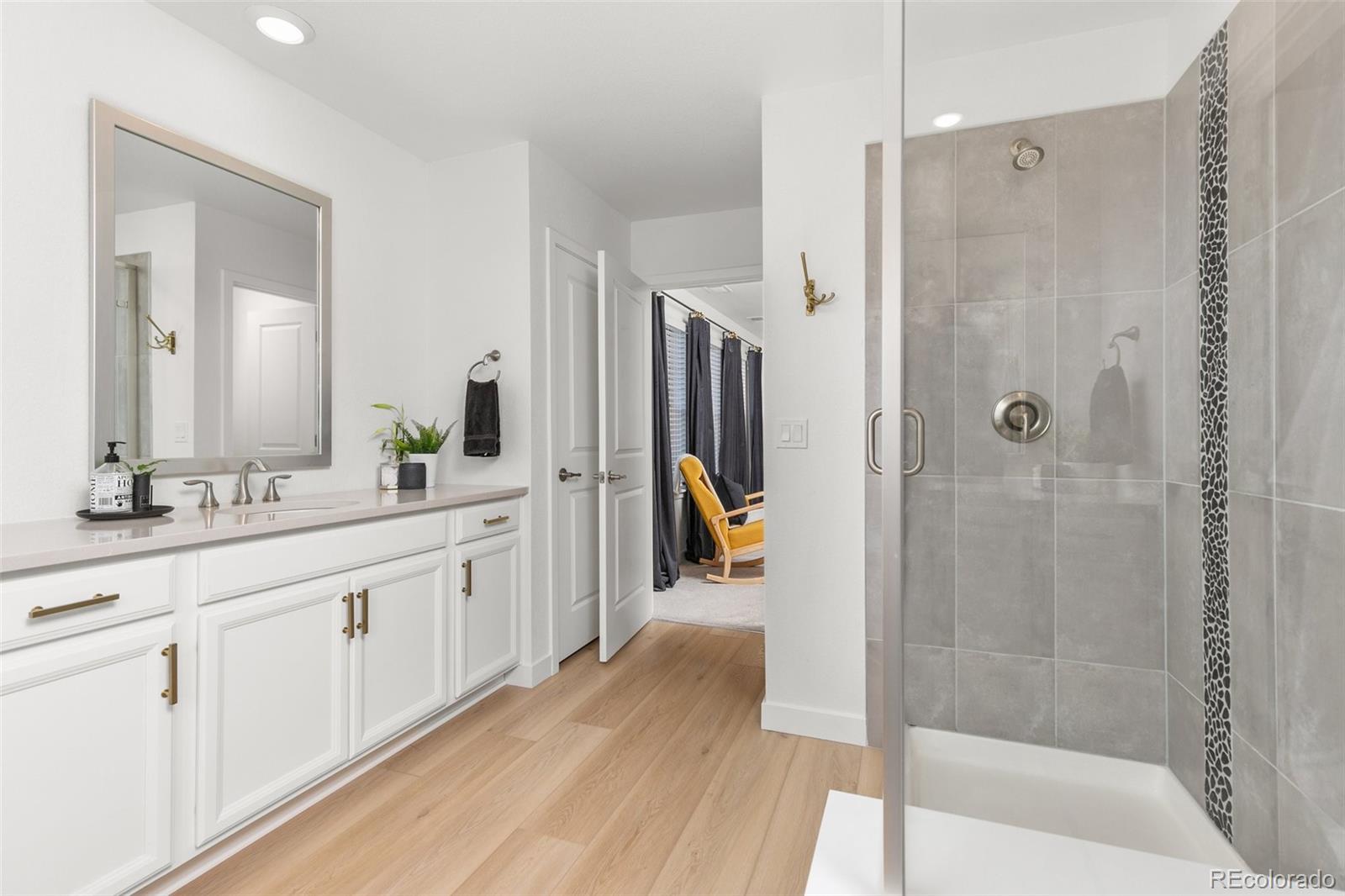 6267 North Florence Way Denver, CO 80238 - Photo 24 of 41 a spacious bathroom with a shower and a sink