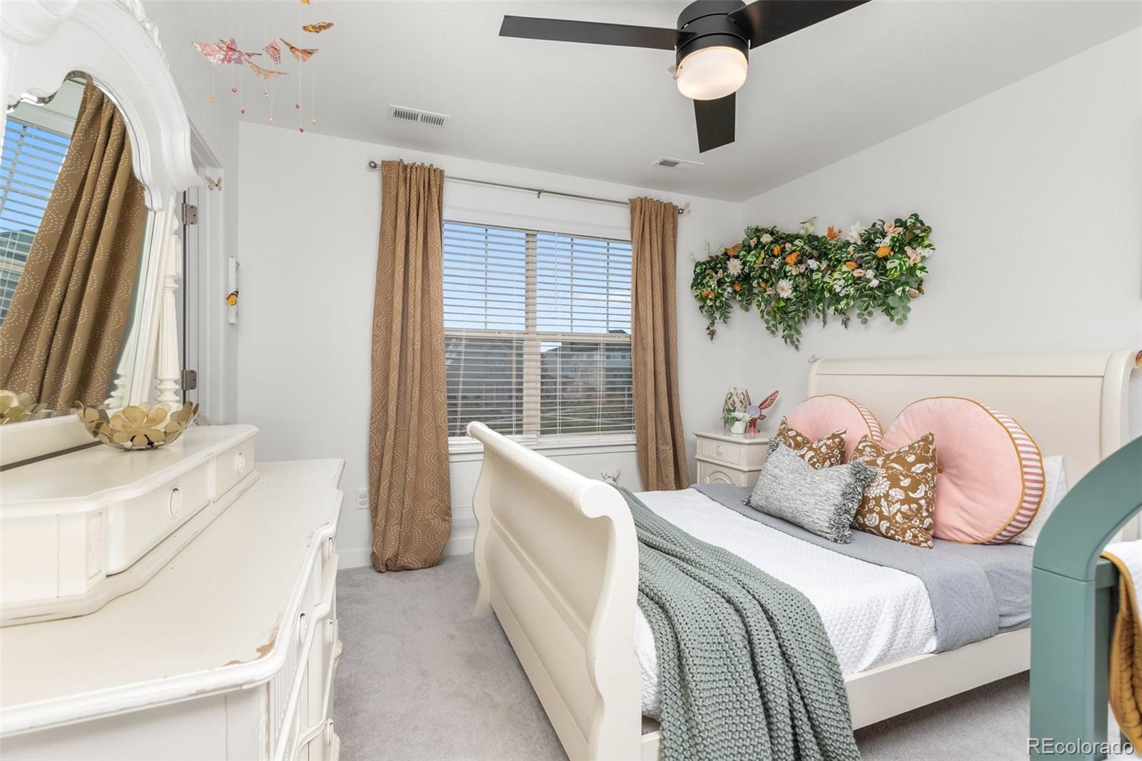6267 North Florence Way Denver, CO 80238 - Photo 27 of 41 a spacious bedroom with a bed and a window