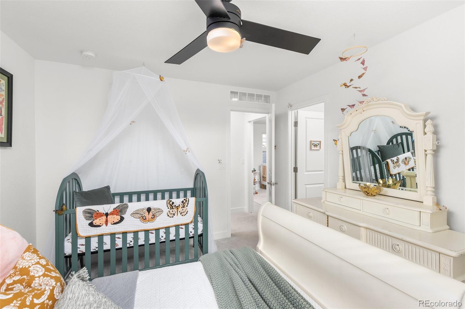 6267 North Florence Way Denver, CO 80238 - Photo 28 of 41 a bedroom with furniture and a bed