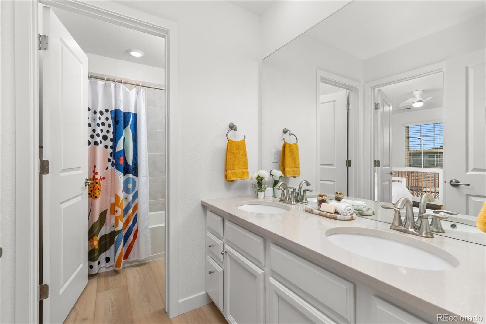 6267 North Florence Way Denver, CO 80238 - Photo 31 of 41 a bathroom with a double vanity sink and mirror