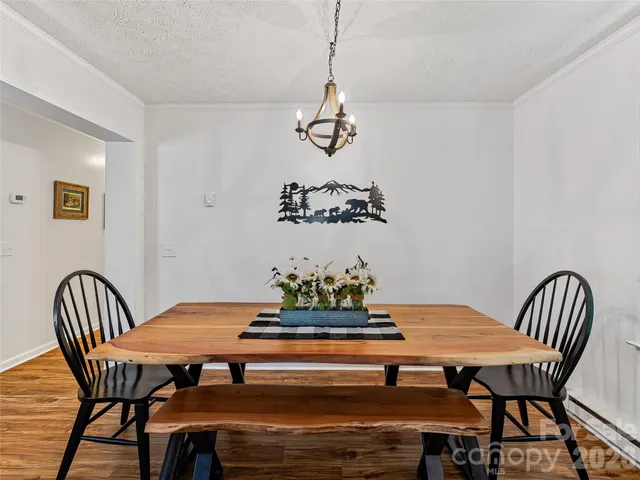 a bedroom with a bed and painting on the wall