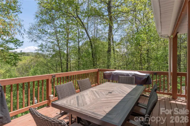 a view of a roof deck with couches and wooden fence
