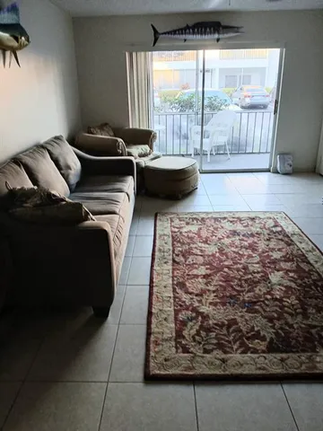 a living room with furniture and a rug