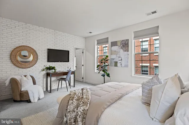 a bedroom with bed and a flat tv screen
