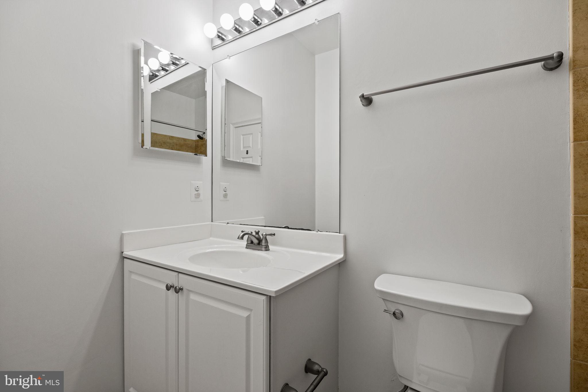 201 Commodore Court Philadelphia, PA 19146 - Photo 40 of 61 a bathroom with a sink a toilet and a mirror