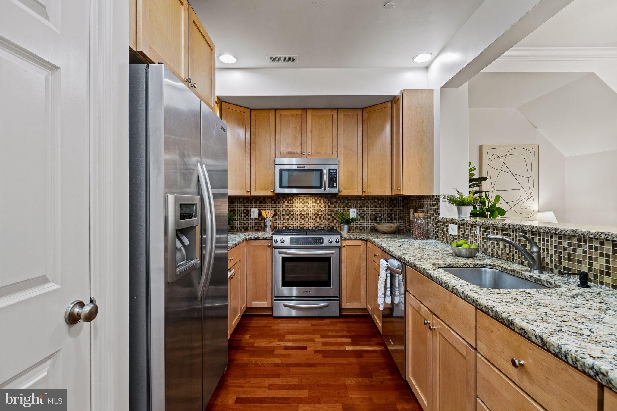 201 Commodore Court Philadelphia, PA 19146 - Photo 10 of 61 a kitchen with stainless steel appliances granite countertop a refrigerator and a sink