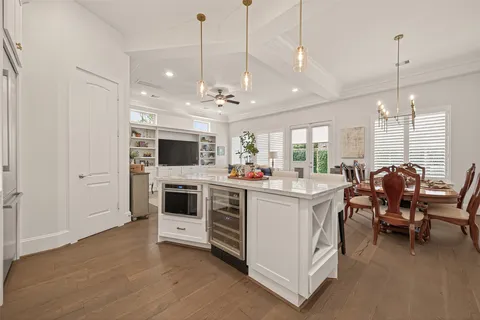 a view of kitchen with microwave a stove and furniture