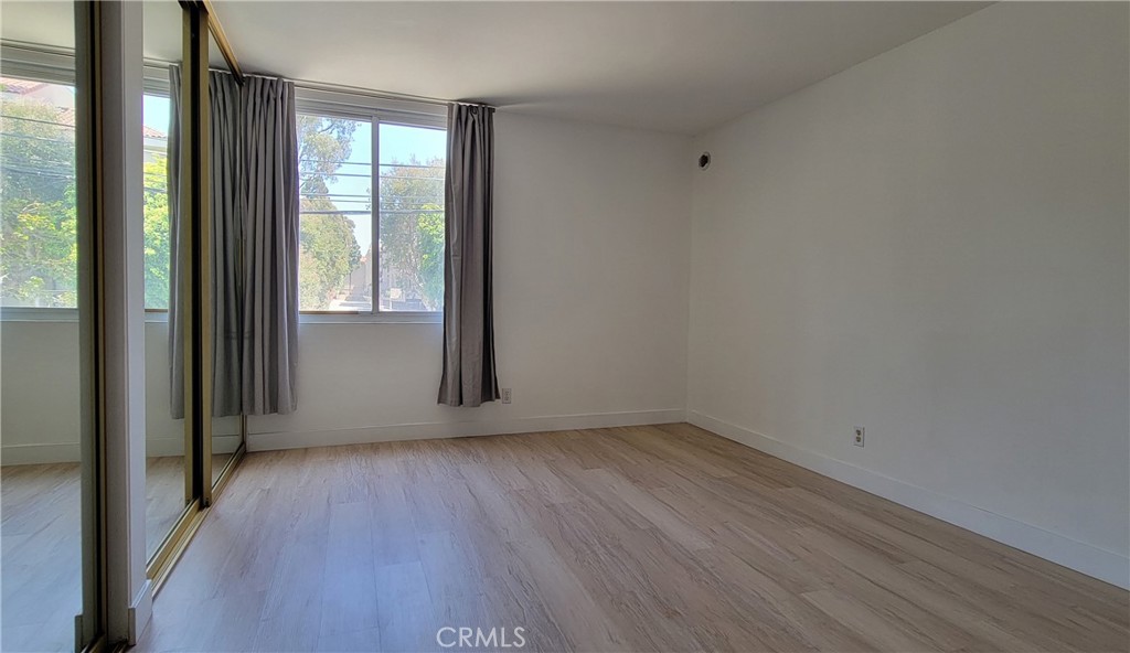 8740 Tuscany Avenue Playa del Rey, CA 90293 - Photo 12 of 21 a view of an empty room with wooden floor and a window