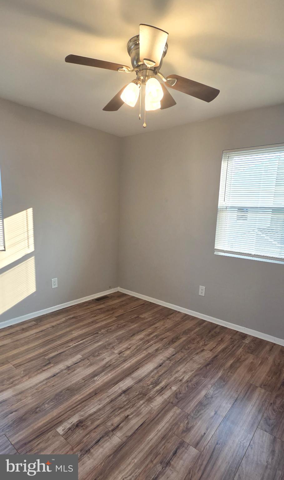 15 Lawrence Court Sicklerville, NJ 08081 - Photo 23 of 33 a view of an empty room with wooden floor and a window