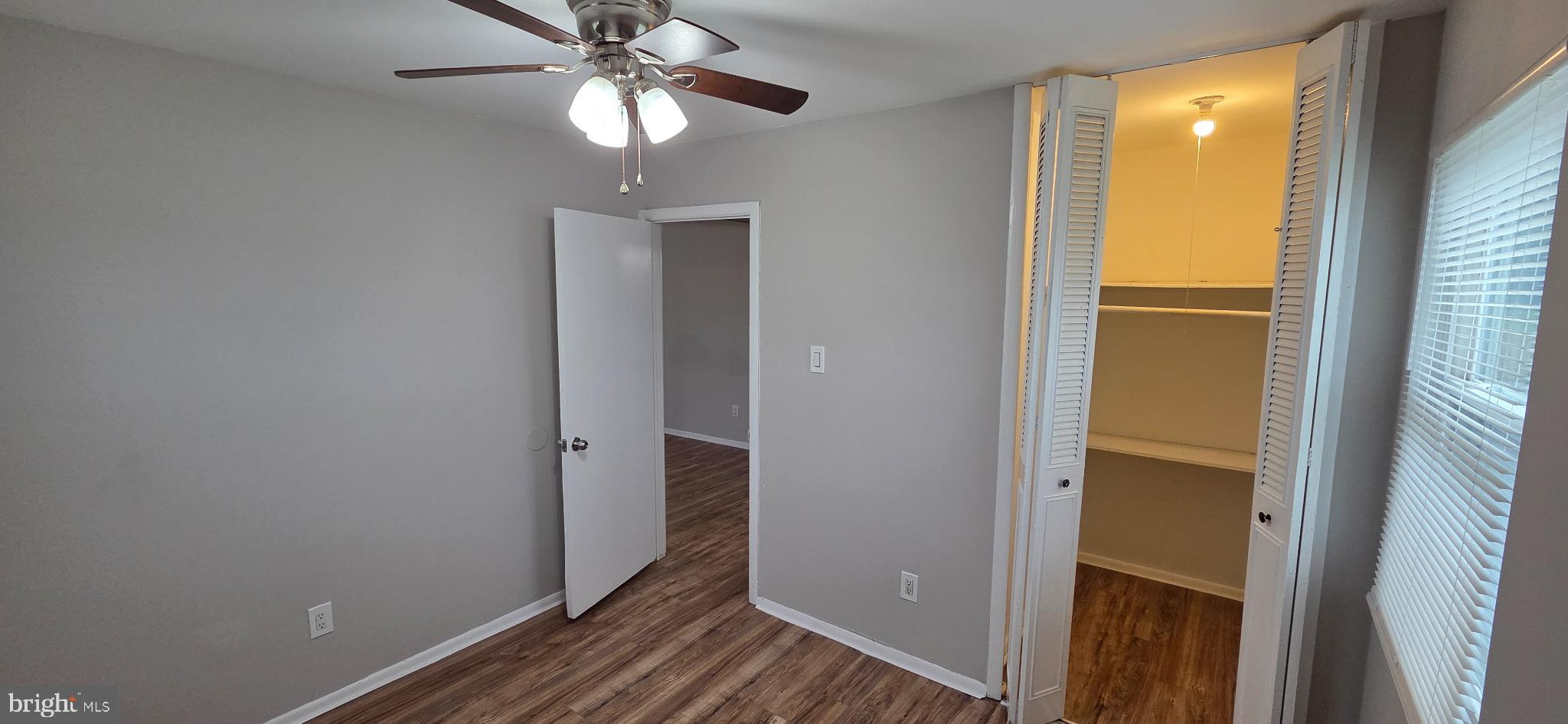 15 Lawrence Court Sicklerville, NJ 08081 - Photo 25 of 33 a view of a hallway with wooden floor and chandelier fan