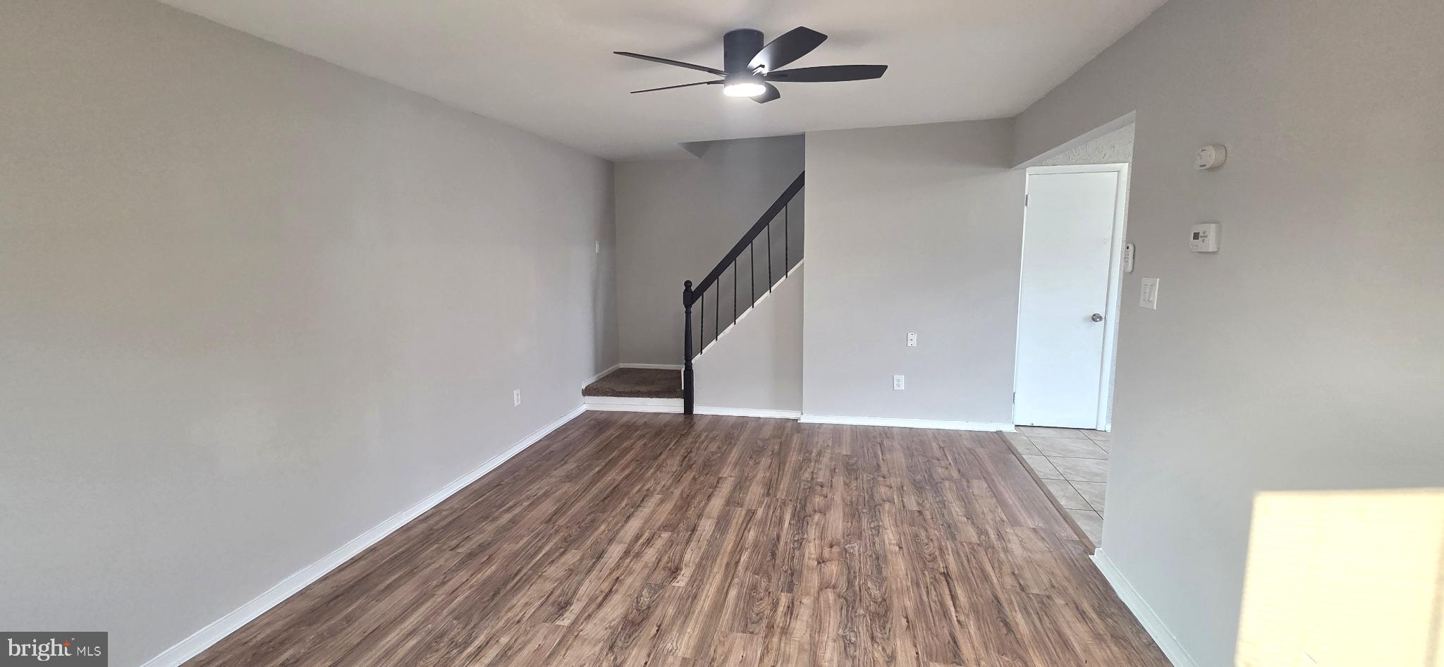 15 Lawrence Court Sicklerville, NJ 08081 - Photo 8 of 33 a view of empty room with wooden floor and fan