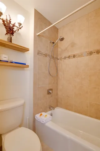 a bathroom with a toilet and shower