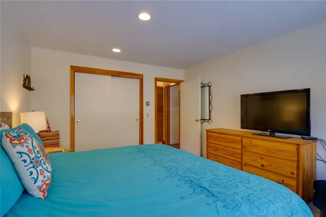 a bedroom with a bed and flat screen tv