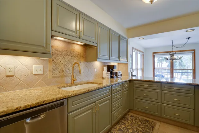 a kitchen with a sink and cabinets