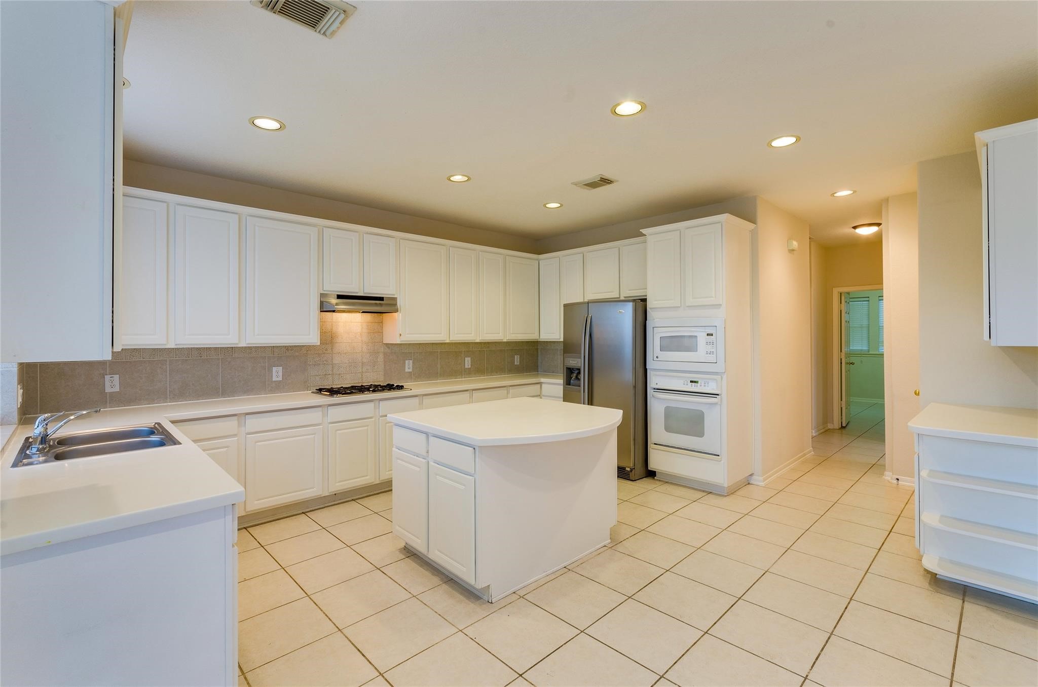 4019 Angel Spring Drive Sugar Land, TX 77479 - Photo 16 of 50 a kitchen with a refrigerator and a stove top oven