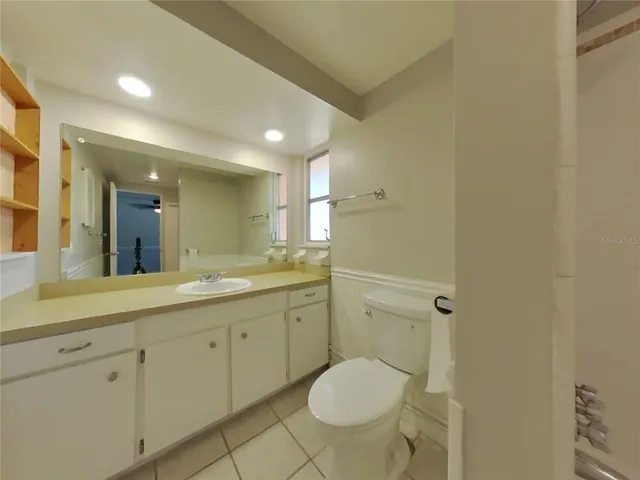 a bathroom with a granite countertop toilet sink and shower